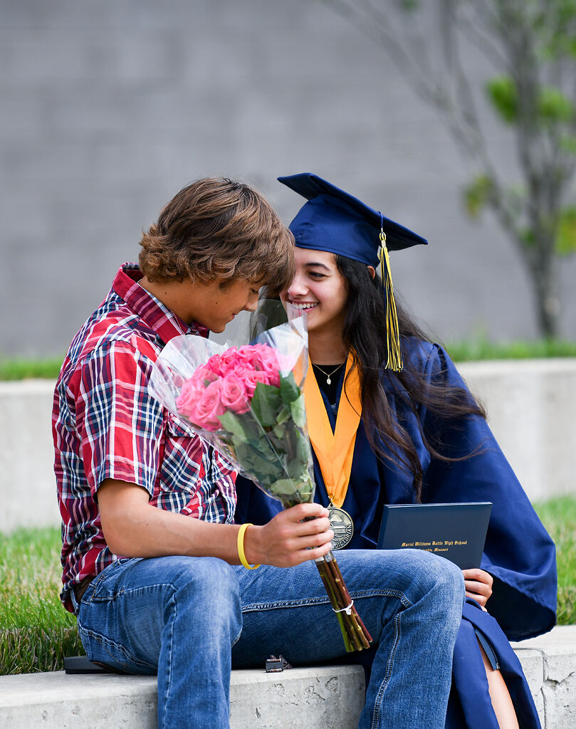 From left, Mason Silverwood and Daniela Calle prepare to pose for a photo after the graduation ceremony